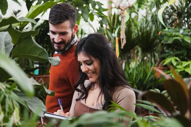 Two people making notes together among leafy plants