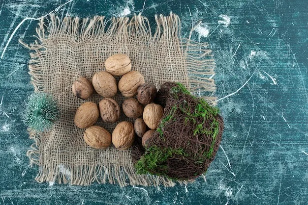 Walnuts in their shells on a piece of burlap beside a small clump of soil